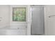 Bathroom with tub and shower behind a glass door at 26 Springbottom Dr, Lawrenceville, GA 30046