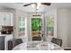 Bright breakfast nook features a ceiling fan and windows overlooking the greenery outside at 26 Springbottom Dr, Lawrenceville, GA 30046