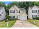 Charming two-story home with a well-maintained lawn and attached one car garage at 26 Springbottom Dr, Lawrenceville, GA 30046