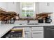 Kitchen featuring modern faucet and counters, lots of drawers and mosaic backsplash at 26 Springbottom Dr, Lawrenceville, GA 30046