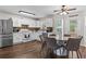Eat-in kitchen with stainless steel appliances, ample cabinet space, and hardwood floors at 26 Springbottom Dr, Lawrenceville, GA 30046