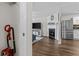 Open-concept layout showing stainless steel refrigerator, fireplace, and living area at 26 Springbottom Dr, Lawrenceville, GA 30046