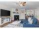 Comfortable living area with a fireplace, ceiling fan, and stylish decor at 26 Springbottom Dr, Lawrenceville, GA 30046