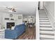 Inviting living room with a fireplace, hardwood floors, and an adjacent staircase at 26 Springbottom Dr, Lawrenceville, GA 30046