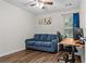This living space boasts a comfortable blue sofa and a desk for working from home at 26 Springbottom Dr, Lawrenceville, GA 30046