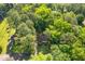 Aerial view of a home nestled among lush trees with a long driveway and ample parking at 2856 Bay Leaf Se Dr, Conyers, GA 30094