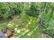 Aerial view showcasing a spacious backyard, mature trees, and a wooden deck, ideal for outdoor enjoyment at 2856 Bay Leaf Se Dr, Conyers, GA 30094