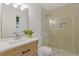 Bathroom featuring a wooden vanity and a glass enclosed shower with pebble flooring at 2856 Bay Leaf Se Dr, Conyers, GA 30094