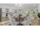 Sunlit dining area open to a kitchen with stainless appliances and a view of the front yard at 2856 Bay Leaf Se Dr, Conyers, GA 30094