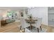 Inviting dining area with modern lighting fixture, open to living room and adjacent to well lit fireplace at 2856 Bay Leaf Se Dr, Conyers, GA 30094
