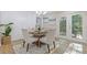 Cozy dining room area featuring a charming table setting, natural light, and easy access to outdoor spaces via French doors at 2856 Bay Leaf Se Dr, Conyers, GA 30094