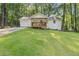 Lovely home featuring a manicured lawn, mature trees, and a charming front porch, great curb appeal at 2856 Bay Leaf Se Dr, Conyers, GA 30094