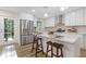 Modern kitchen featuring white cabinets, stainless steel appliances, and a center island with seating and space for food prep at 2856 Bay Leaf Se Dr, Conyers, GA 30094