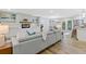 Open-concept living room featuring hardwood floors, a modern fireplace, and seamless flow into the dining and kitchen areas at 2856 Bay Leaf Se Dr, Conyers, GA 30094
