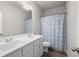 Bathroom with double sinks, a shower with patterned curtain, and modern fixtures at 33 N Village Cir, Rydal, GA 30171