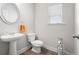 Half-bath with a pedestal sink, modern fixtures, and neutral decor at 33 N Village Cir, Rydal, GA 30171