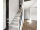 Bright entryway featuring a carpeted staircase, wood flooring, and a modern front door at 33 N Village Cir, Rydal, GA 30171