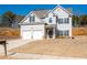 Charming two-story home with a two-car garage, well-maintained lawn, and traditional architectural details at 33 N Village Cir, Rydal, GA 30171