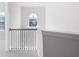 Upstairs hallway with a black metal railing and lots of natural light at 33 N Village Cir, Rydal, GA 30171