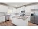 Bright kitchen with white cabinets, granite countertops, stainless steel appliances, and hardwood floors at 33 N Village Cir, Rydal, GA 30171