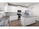 Modern kitchen with white cabinetry, stainless steel appliances, and granite countertops at 33 N Village Cir, Rydal, GA 30171