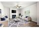 Comfortable living room with modern fireplace, plush seating, ceiling fan and large windows for plenty of natural light at 33 N Village Cir, Rydal, GA 30171