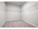 Walk-in closet with carpet, white walls, and a white metal shelving system along the upper perimeter at 33 N Village Cir, Rydal, GA 30171