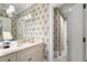 Bright bathroom features floral wallpaper, marble countertop, and ample storage at 122 Old Ivy Ne Rd # 17, Atlanta, GA 30342