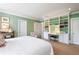 This bedroom includes a built-in bookcase, a desk and neutral carpeting at 122 Old Ivy Ne Rd # 17, Atlanta, GA 30342
