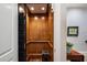 Interior view of an elevator with wood paneling, a small stool and recessed lights at 122 Old Ivy Ne Rd # 17, Atlanta, GA 30342