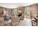 Cozy living room with fireplace, French doors, and custom built-in bookshelves at 122 Old Ivy Ne Rd # 17, Atlanta, GA 30342
