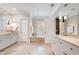 Bright bathroom features dual vanities, neutral finishes, and soaking tub under the window at 122 Old Ivy Ne Rd # 17, Atlanta, GA 30342