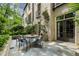 Charming outdoor patio with brick facade, landscaping, and an outdoor dining set at 122 Old Ivy Ne Rd # 17, Atlanta, GA 30342