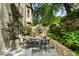 Idyllic patio area with stone tile, lush greenery, and a wrought-iron dining set at 122 Old Ivy Ne Rd # 17, Atlanta, GA 30342