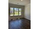 Bright bedroom featuring hardwood floors and three large windows with great views at 3706 Cheswolde Ave # 96, Powder Springs, GA 30127