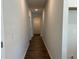 Bright hallway with wood floor leading to rooms with neutral paint at 3706 Cheswolde Ave # 96, Powder Springs, GA 30127