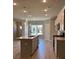 Modern kitchen with a large island, quartz countertops, stainless steel appliances, and pendant lighting at 3706 Cheswolde Ave # 96, Powder Springs, GA 30127
