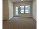 Living room with lots of light coming through the windows with carpeted floor at 3706 Cheswolde Ave # 96, Powder Springs, GA 30127