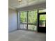 Relaxing screened patio with wooded view and paneled ceiling detail at 3706 Cheswolde Ave # 96, Powder Springs, GA 30127