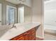 Bathroom with cherry wood cabinets, laminate countertop, and mirror at 721 Beaufort Cir, Duluth, GA 30096