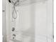 A clean white bathtub with a shower head attached and white walls at 721 Beaufort Cir, Duluth, GA 30096