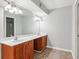 The bathroom has double sinks, wooden cabinets, and tile flooring at 721 Beaufort Cir, Duluth, GA 30096