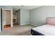 Bedroom features carpet, closet, and entrance to bathroom and doorway at 721 Beaufort Cir, Duluth, GA 30096