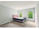 Bedroom features carpet, two windows with natural light, and a blush colored bed frame at 721 Beaufort Cir, Duluth, GA 30096