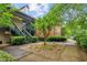 Exterior view of a multi-story condo building featuring a well maintained lawn, landscape, and stairs to the units at 721 Beaufort Cir, Duluth, GA 30096