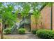 Attractive condo building featuring stairs, a covered porch, and well maintained landscape in a suburban setting at 721 Beaufort Cir, Duluth, GA 30096