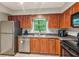Kitchen featuring stainless steel appliances, wood cabinets, and ample counter space at 721 Beaufort Cir, Duluth, GA 30096
