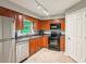 The kitchen boasts stainless steel appliances, wood cabinets, and tile flooring at 721 Beaufort Cir, Duluth, GA 30096