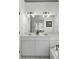Elegant bathroom featuring double sinks, white cabinets, and bright lighting with a large mirror at 78 Crumley Se St, Atlanta, GA 30312
