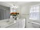 Bright bathroom features a double sink vanity with marble countertop, large mirror, and a window for natural light at 78 Crumley Se St, Atlanta, GA 30312